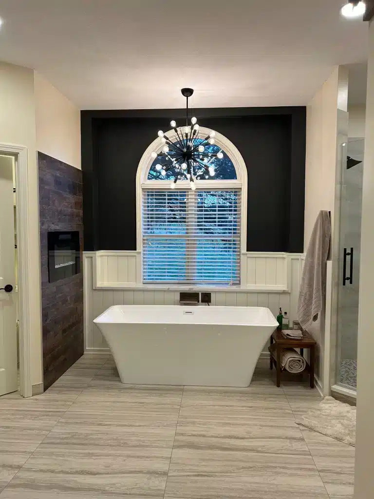 Modern primary bathroom featuring layered ambient LED lighting, an illuminated smart vanity mirror, and Schluter-DITRA-HEAT flooring infrastructure.